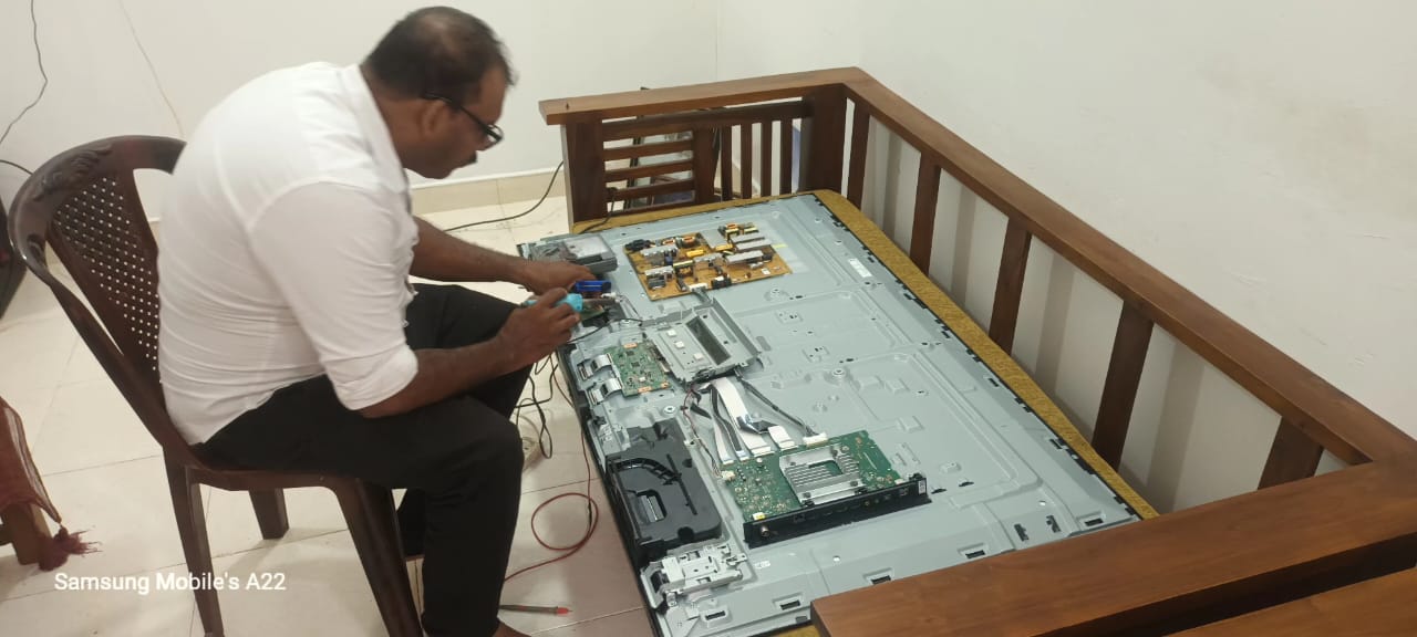 Kairos Electronics technician repairing TV motherboard